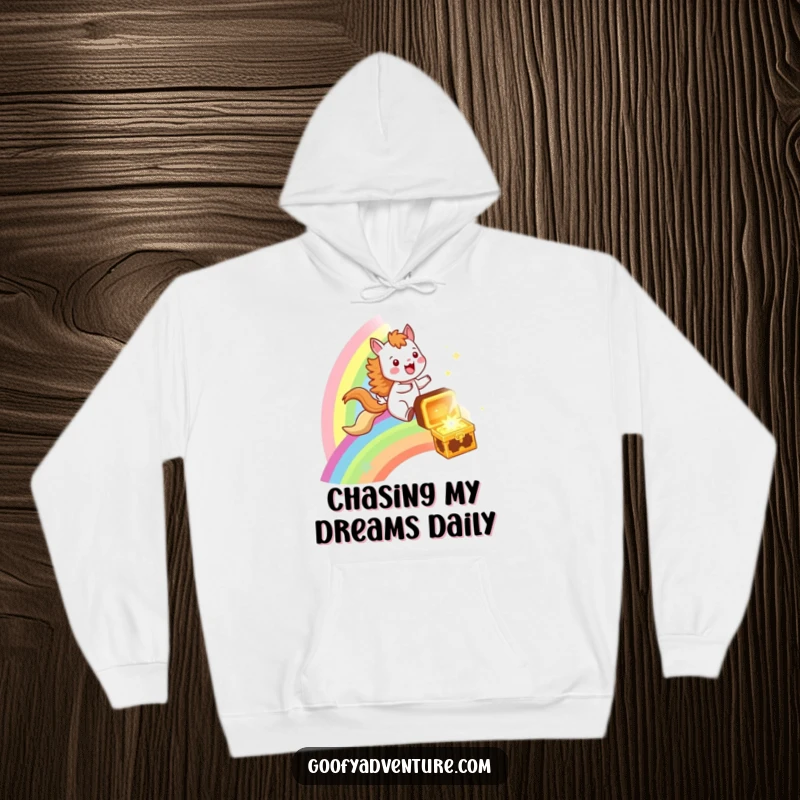 Funny hoodie with a cheerful animal riding a vibrant rainbow, galloping towards a treasure chest, evoking feelings of excitement and warmth.