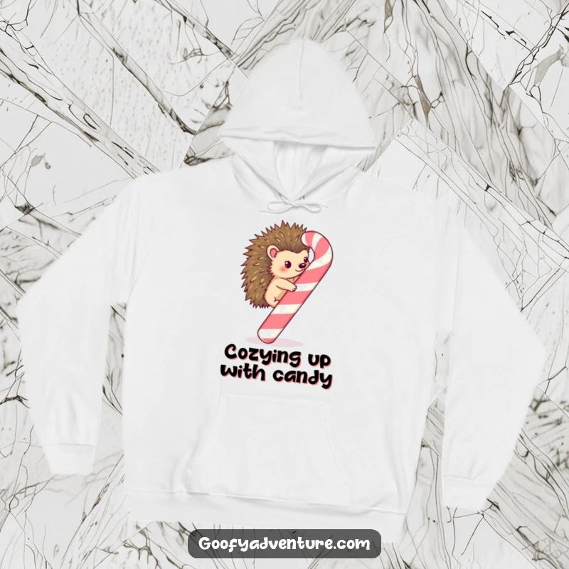 Funny Kawaii hedgehog scaling a huge, whimsical candy cane on a cozy hoodie, perfect for winter merriment.