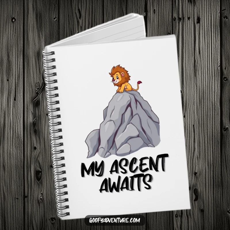 Funny brave lion character scaling a rocky mountain peak, spiral notebook, adventure theme, great funny gift.